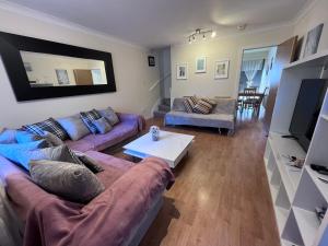 a living room with a couch and a table at River Bay Beautiful 2-Bed House in Cardiff in Cardiff