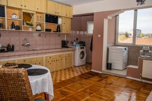 a kitchen with a sink and a washing machine at Vilhelmov’s apartament in Lukovit