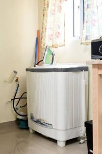 a white heater in a room with a window at Maravilloso Apto en Santo Domingo in Santo Domingo