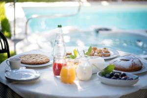 a table with breakfast foods and drinks on it at Il Giardino degli Allori in Campo Calabro