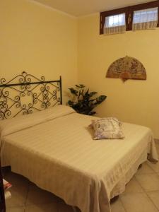 a bedroom with a bed with a white bedspread at " La casa di Elena " in Pietrasanta