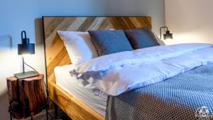 a bedroom with a bed with blue and white pillows at Agroturystyka Corno Owca in Żabnica