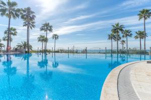 The swimming pool at or close to High standard beach front apartment