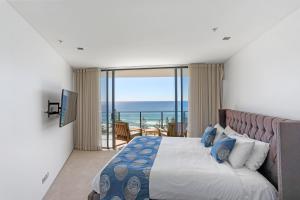 a hotel room with two beds and a large window at Ambience on Burleigh Beach in Gold Coast