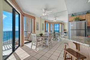 a kitchen and dining room with a view of the ocean at Phoenix 7 Unit 1411 in Orange Beach
