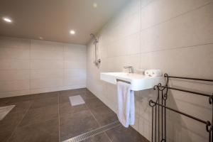 a bathroom with a sink and a tiled wall at Matagouri Cottage - Port Levy Holiday Home in Port Levy +33 photos
