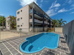 a swimming pool in front of a building at Shoal Bay Beach Apartments Unit 17 2 Shoal Bay Road in Nelson Bay