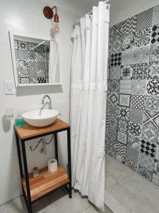 a bathroom with a sink and a shower curtain at Bella Vista 5 in Esquel