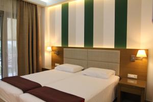 Postel nebo postele na pokoji v ubytování Achilles Hotel