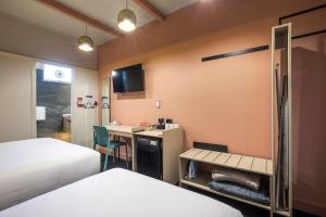 a hotel room with a bed and a television at Nightcap at Sandbelt Hotel in Moorabbin