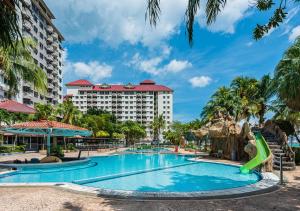 a pool at the resort with a slide at 1-6Pax Port Dickson 2BR Glory Beach Resort Seaview in Port Dickson