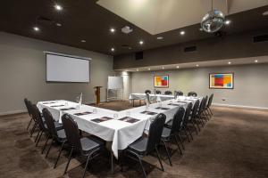 a conference room with a long table and chairs at Nightcap at Sandbelt Hotel in Moorabbin
