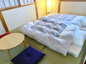 Säng eller sängar i ett rum på Nara Family HOUSE