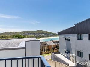 an apartment balcony with a view of the beach at Fingal Bay Seabreeze Unit 2 16 Tuna Crescent in Fingal Bay
