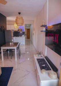 a living room with a kitchen and a dining room at Luxury Apt. With Rooftop in the Heart of San Juan in SJM