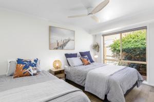 a bedroom with two beds and a window at 2 Bedroom Unit - Close To The Beach - Free Parking - Free WIFI in Ocean Grove