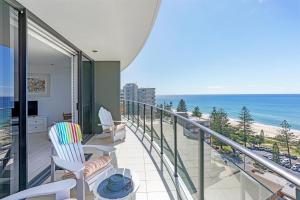 a beach scene with a balcony overlooking the ocean at Ambience on Burleigh Beach in Gold Coast