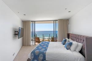 a bedroom with a bed with a view of the ocean at Ambience on Burleigh Beach in Gold Coast +230 photos