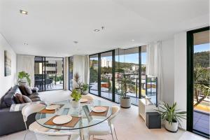 a living room with a couch and a table at Ambience on Burleigh Beach in Gold Coast
