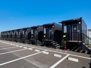 a row of black containers in a parking lot at HOTEL R9 The Yard Higashiomi in Higashiomi