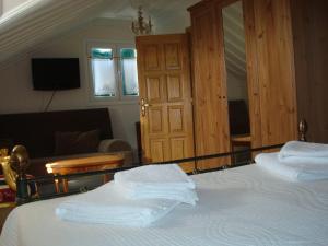 a bedroom with a bed with a mirror on it at Merlot Village Rental Apartments in Kariá