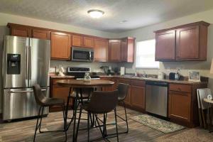 a kitchen with wooden cabinets and a table with chairs at Diamond in the Rough-696 in Middletown