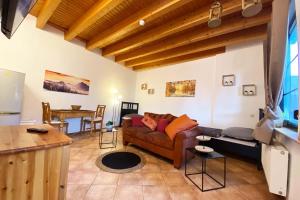 a living room with a couch and a table at Gemütliches Reiheneckhaus mit Balkon in Burscheid