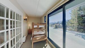 a room with a glass door leading to a balcony at Lakeview 826 Condo #108 Condo in Mammoth Lakes +39 photos