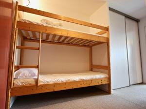 a couple of bunk beds in a room at Studio Chamrousse, 1 pièce, 6 personnes - FR-1-340-208 in Chamrousse