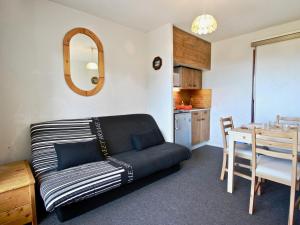 a living room with a couch and a table at Studio Chamrousse, 1 pièce, 6 personnes - FR-1-340-86 in Chamrousse