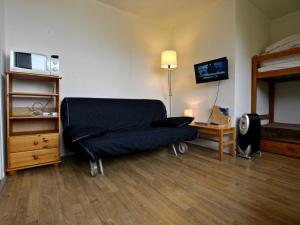 a room with a bed and a couch in a bedroom at Studio Chamrousse, 1 pièce, 3 personnes - FR-1-340-109 in Chamrousse