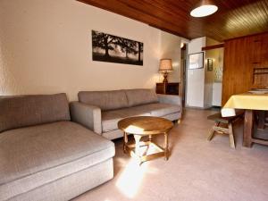 a living room with a couch and a table at Appartement Chamrousse, 2 pièces, 6 personnes - FR-1-340-147 in Chamrousse