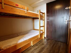 Cette chambre comprend 2 lits superposés et une porte. dans l'établissement Studio Chamrousse, 1 pièce, 4 personnes - FR-1-340-153, à Chamrousse