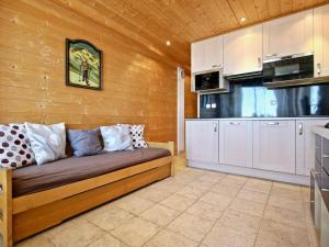 a living room with a couch in a kitchen at Studio Chamrousse, 1 pièce, 4 personnes - FR-1-549-22 in Chamrousse