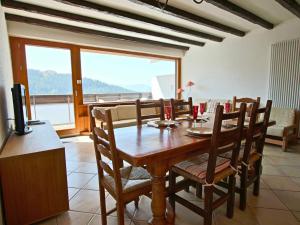 una sala da pranzo con tavolo e sedie e vista di Appartement Chamrousse, 3 pièces, 6 personnes - FR-1-340-204 a Chamrousse