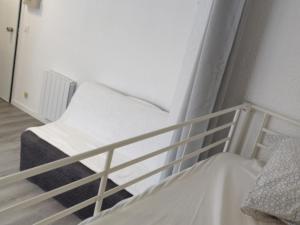 a white bunk bed in a white room at Studio Chamrousse, 1 pièce, 4 personnes - FR-1-340-214 in Chamrousse