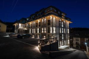 a large building with lights on it at night at Vista47 Zoned II Kopaonik in Kopaonik