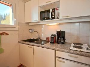 uma cozinha com um lavatório e um micro-ondas em Appartement Chamrousse, 2 pièces, 4 personnes - FR-1-340-210 em Chamrousse