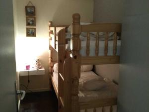 a bedroom with a wooden bunk bed in a room at Appartement Chamrousse, 2 pièces, 6 personnes - FR-1-549-54 in Chamrousse