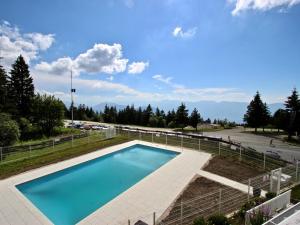a swimming pool in a yard with a parking lot at Studio Chamrousse, 1 pièce, 4 personnes - FR-1-549-48 in Chamrousse
