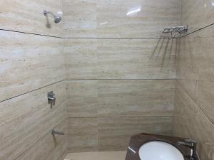 a bathroom with a shower with a toilet and a sink at Hotel Mount Way in Ābu Road