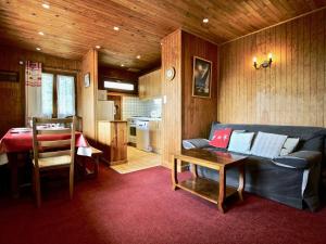 a living room with a couch and a table at Appartement Chamrousse, 4 pièces, 8 personnes - FR-1-340-232 in Chamrousse