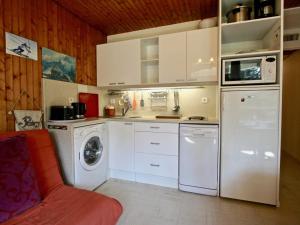 a kitchen with a white refrigerator and a washer at Studio Chamrousse, 1 pièce, 4 personnes - FR-1-549-61 in Chamrousse