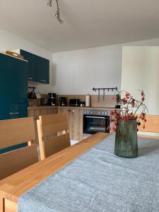 a kitchen with a table with a vase of flowers on it at Ferienwohnung Birka in Speyer