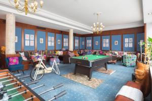 a billiard room with a pool table in the middle at Tante ALMA's Mannheimer Hotel in Mannheim