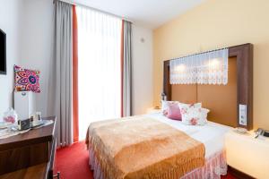 Postel nebo postele na pokoji v ubytování Tante ALMA's Mannheimer Hotel