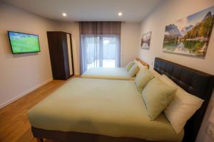 a bedroom with a large bed and a couch at Cozy Apartment With Garden in Fátima