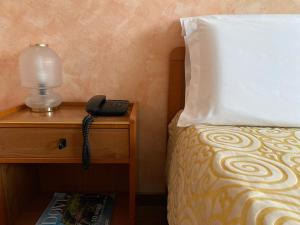 Postel nebo postele na pokoji v ubytování Hotel Ristorante SASSO