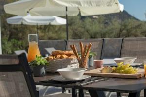 a table with a basket of bread and snacks on it at Elysian villas in Palaiokatoúna