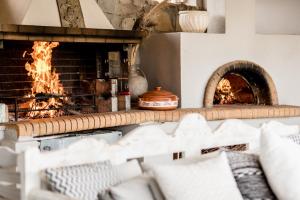 a brick oven with a fire in it at Casa Della Vita Gouves Cretan Luxury Villa in Gournes